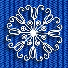 Snowflake on blue knitted background