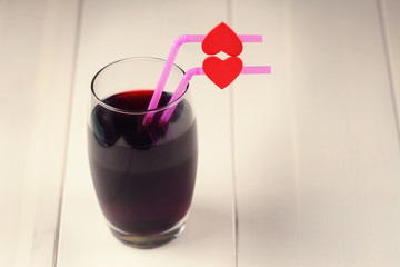 Cherry juice glass with red hearts as a kissing lips