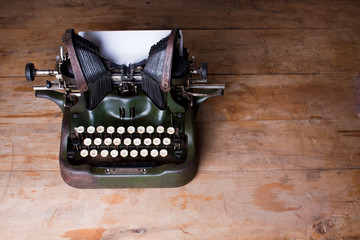 Top view of an old typewriter on a wooden table