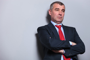 Mid aged business man holding his arms crossed