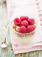 Yogurt with muesli and fresh raspberries