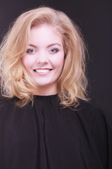 Fototapeta premium Beautiful smiling girl with blond wavy hair in hairdressing 
