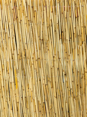 Yellow straw mat surface pattern background texture.