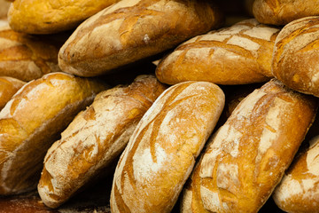 many brown rustic fresh rye bread loaves