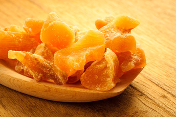 Closeup candied ginger on wooden spoon