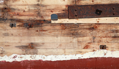 Old wooden ship fragment, hull under renovation, background phot