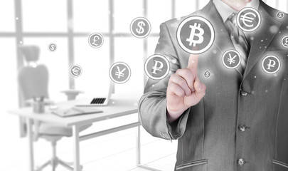 Choosing bitcoins, businessman pressing touch screen button.