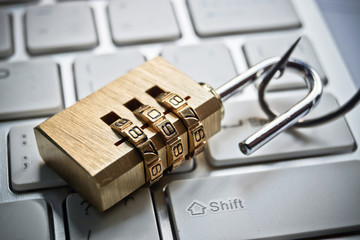 security lock on computer keyboard with a fish hook