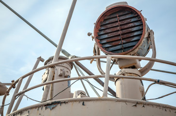 Rusted signal light mounted on captain bridge of an old ship