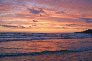 Brilliant Coastal Sunset With Distant Lighthouse