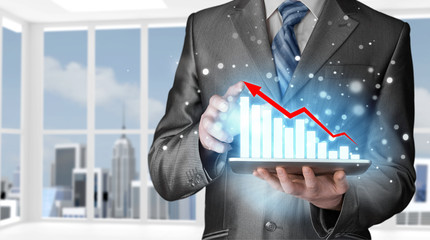 business man using tablet computer to work with financial data