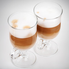 Two glasses with handles of latte coffee