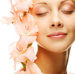 fresh face with gladiolus flowers in her hands