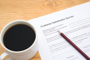 customer service satisfaction survey form and cup of coffee