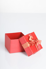 An empty red gift box with the lid off