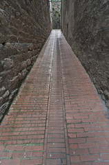 Fototapeta na wymiar Narrow medieval street in Pienza, Tuscany, Italy