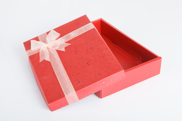 An empty red gift box with the lid off