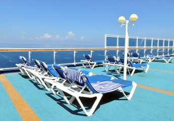  Lounge chairs on a cruise ship deck overlooking the ocean       - 71463456
