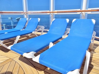  Lounge chairs on a cruise ship deck overlooking the ocean      