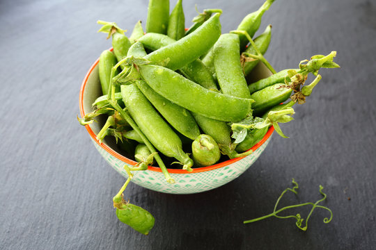 fresh peas in a white bowl