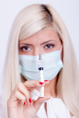 Female doctor or nurse in medical mask, corona virus vaccine