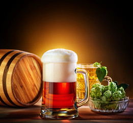 Beer barrel with beer glass on a wooden table. The dark backgrou