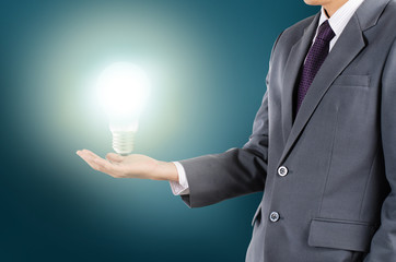 Businessman holding lamp as new get idea