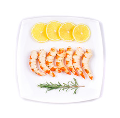 Cooked unshelled shrimps with lemon.