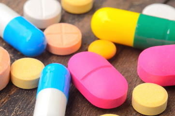 medicine capsule pill on wood background