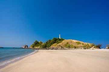 Old lighthouse and white sand beach on Koh Lanta Yai island cape