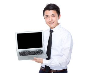 Businessman show with blank screen of laptop computer