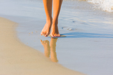 Female leg walking on the beach