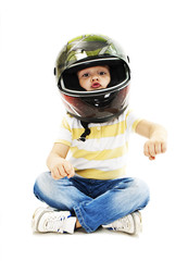 Boy with a helmet, pretending to drive a motorcycle
