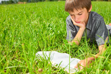 Child reading book outdoor