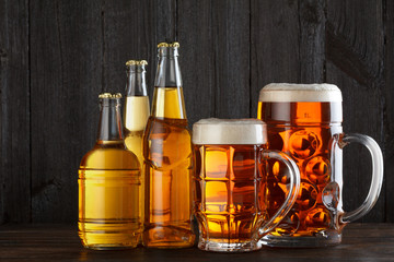 Assortment of beer glasses and bottles on table