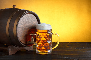 Vintage beer barrel with huge beer glass