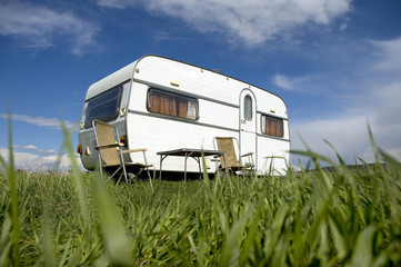 caravan camping with table and two chars