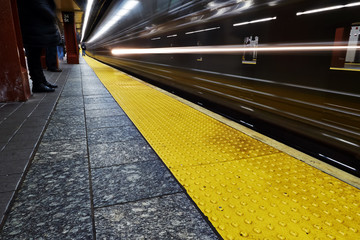 Subway yellow line with train approaching 