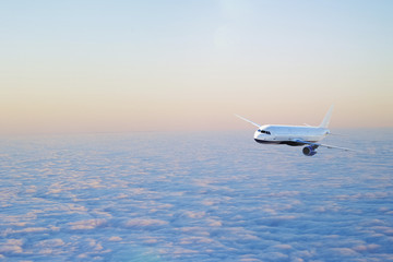 Naklejka na ściany i meble Airplane flying above clouds