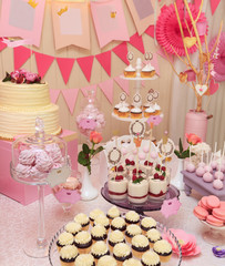 Sweet holiday buffet with cupcakes and meringues
