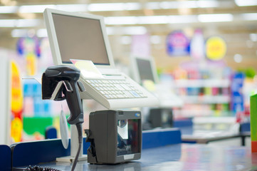 Empty cash desk with computer terminal in supermarket