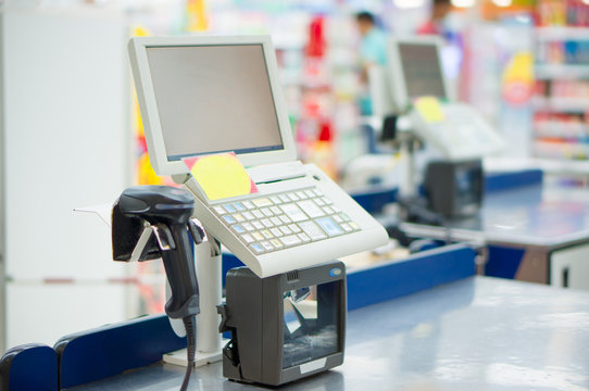 Empty cash desk with computer terminal in supermarket