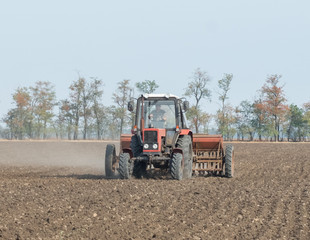 tractor and seeder planting crops on a field