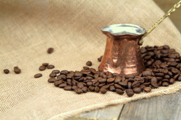 Coffee beans and traditional Turkish copper coffee pot