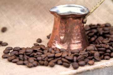 Coffee beans and traditional Turkish copper coffee pot