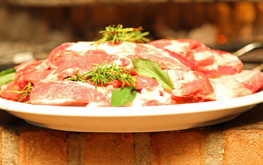 raw meat dish with Rosemary ready to be cooked on the grill