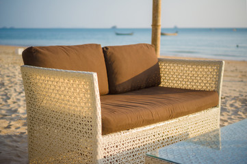Fototapeta na wymiar Luxury beach sofa and table on tropical island beach