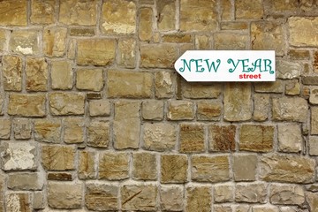 Fototapeta na wymiar Direction Signboard on the old stone wall