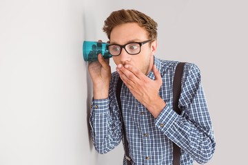 Geeky businessman eavesdropping with cup