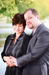 Young couple at a lake in summer park
